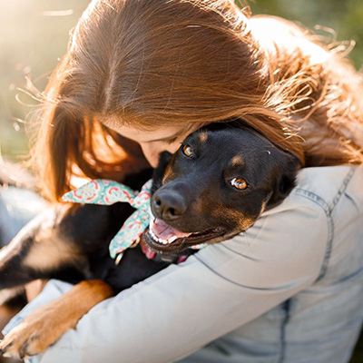 Dog hug! Dog trainer giving her dog a hug in Salt Lake City